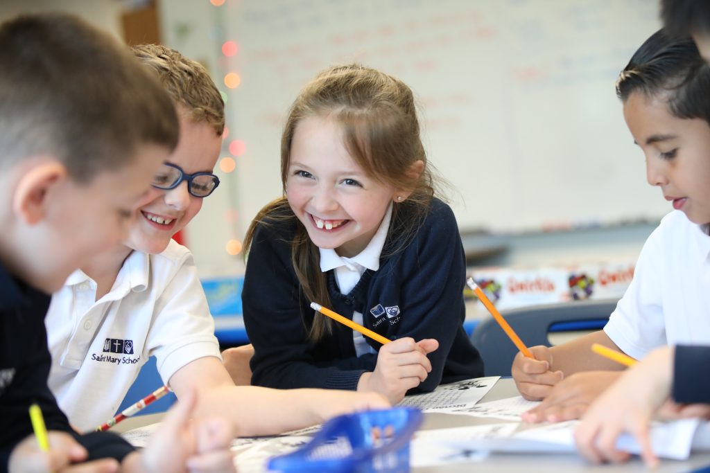 Students smiling while working together