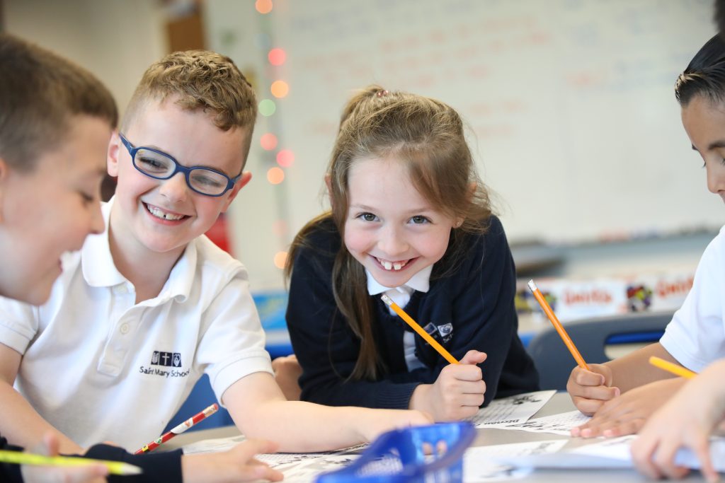 Girlwith pencil andboy smiling