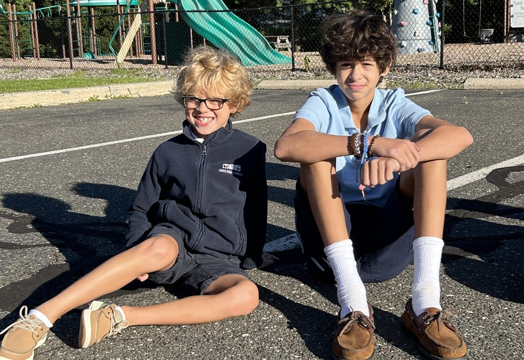 a Grade 2 and Grade 8 buddy pair sitting playing duck duck goose