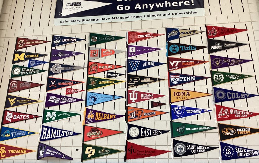 College pennants on the gym wall at Saint Mary School