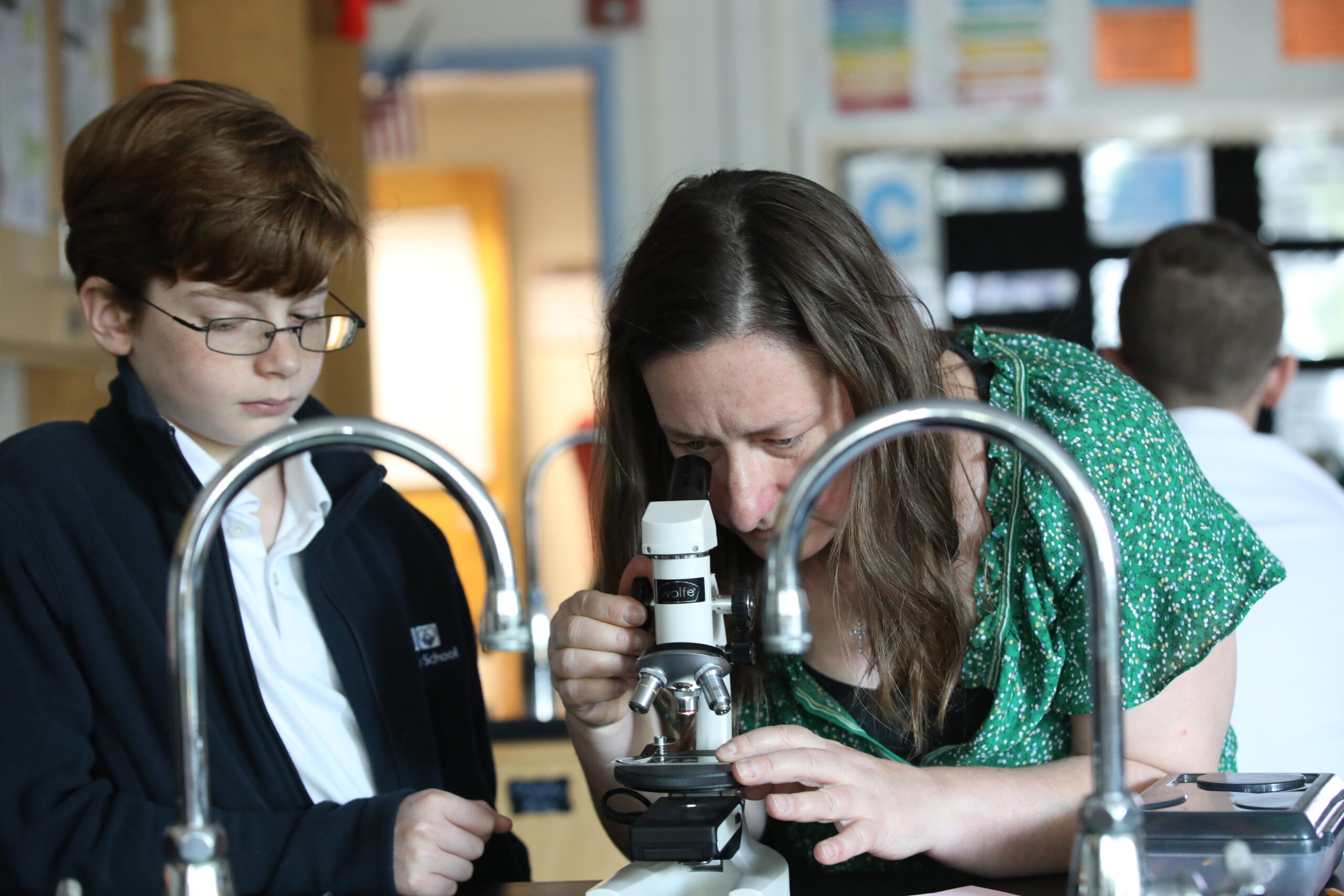 Middle School Science Teacher Melissa Kennedy with a student