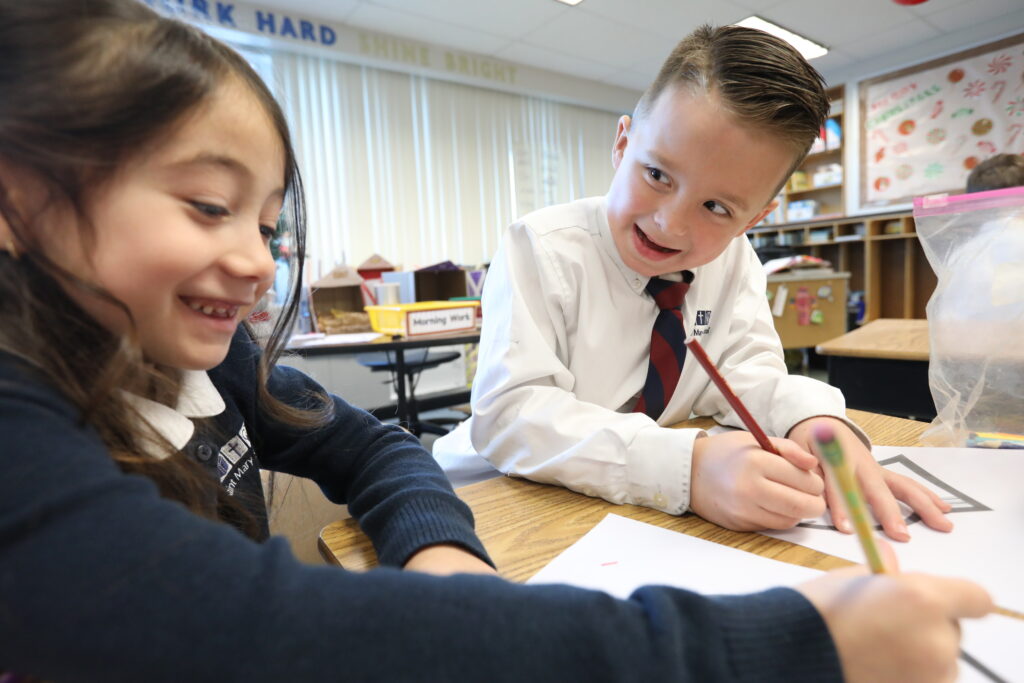 Grade 1 boy and girl working at desks