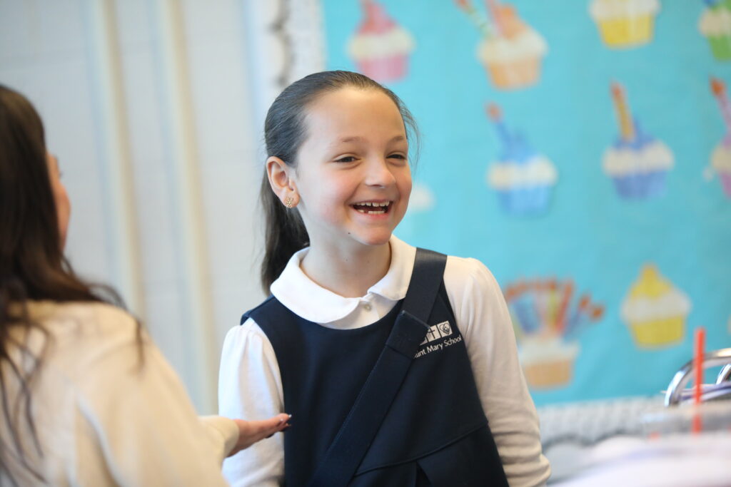 Elementary ages girl laughing and smiling