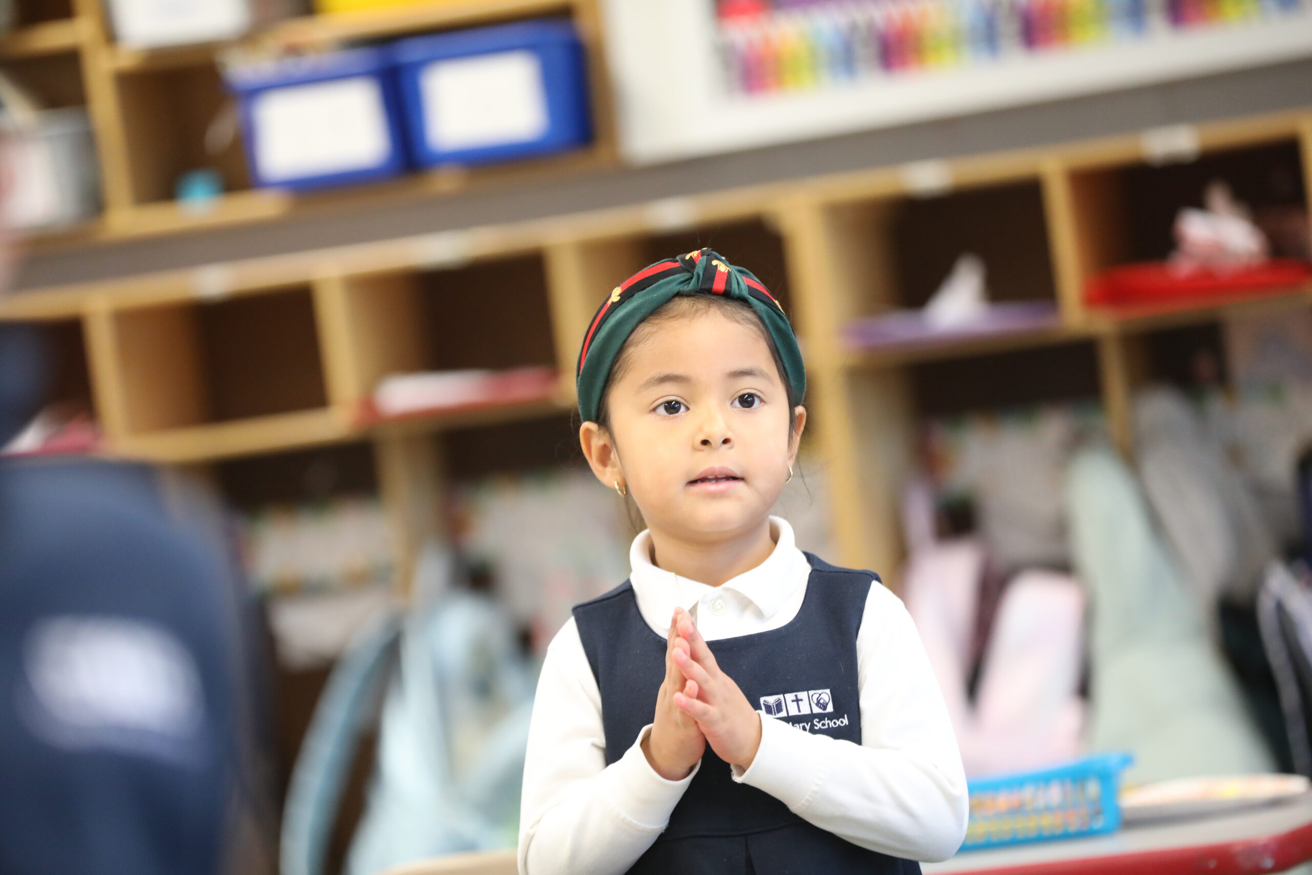 Kindergarten girl during morning prayer