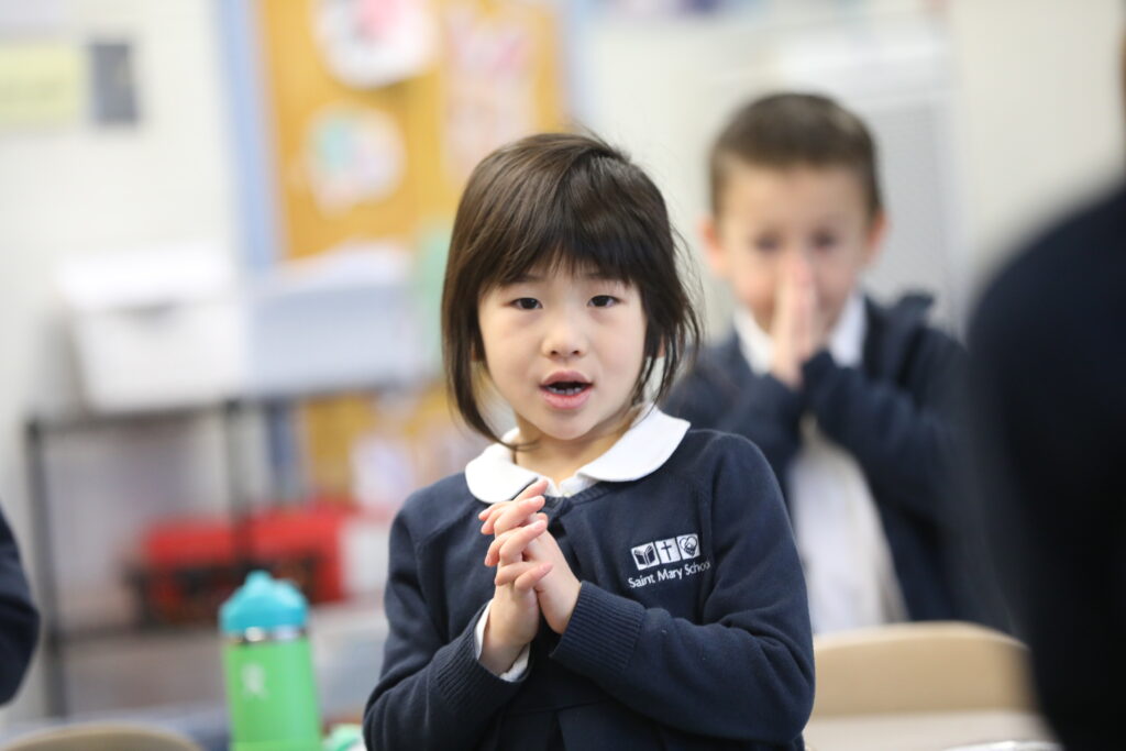 Little Girl in Prayer with Boy in Background