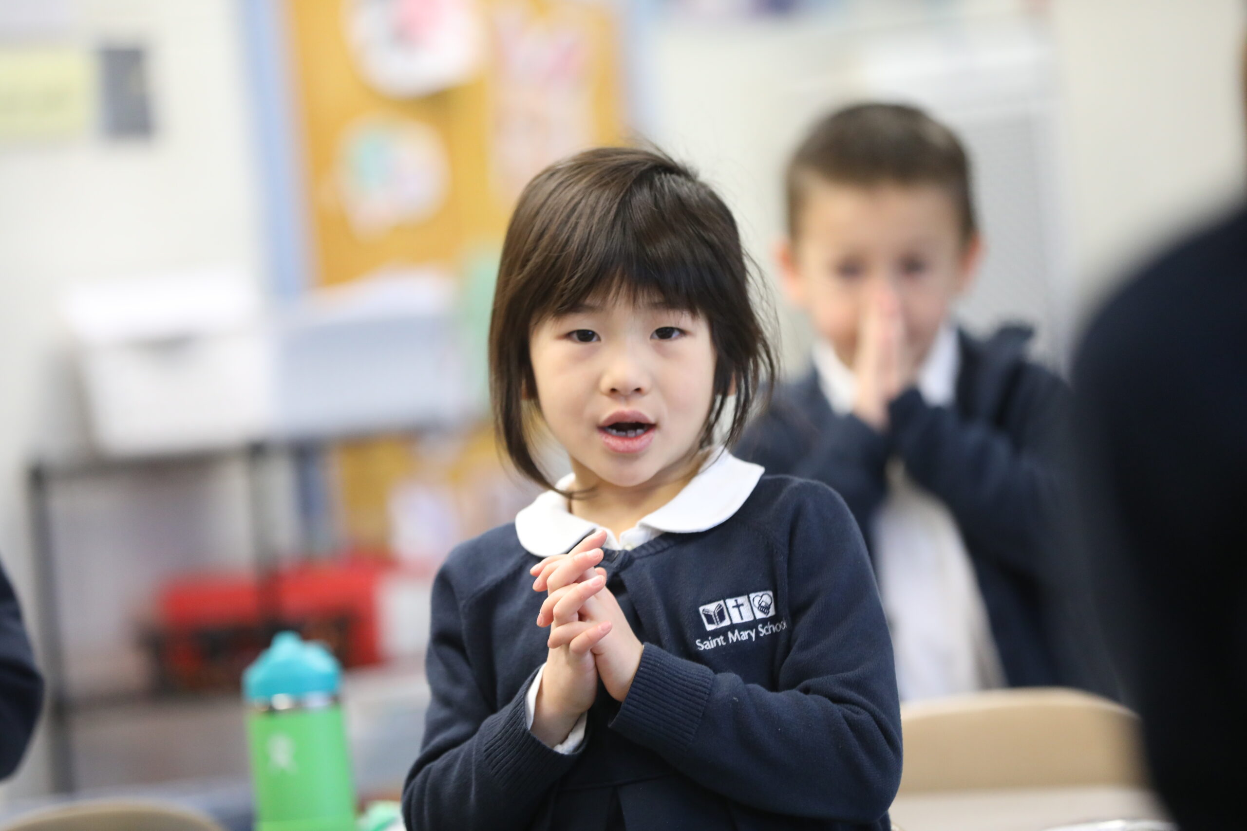 Little Girl in Prayer with Boy in Background