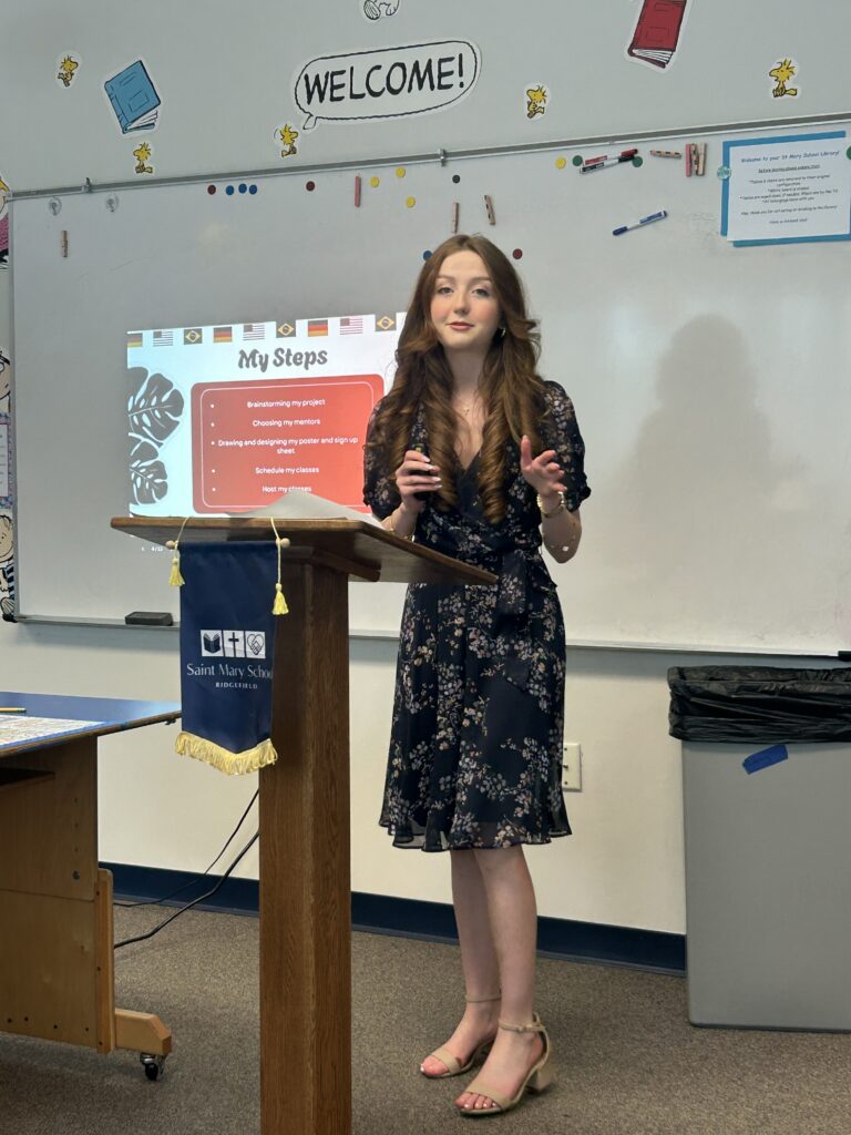 8th Grade girl presenting to the Capstone Board